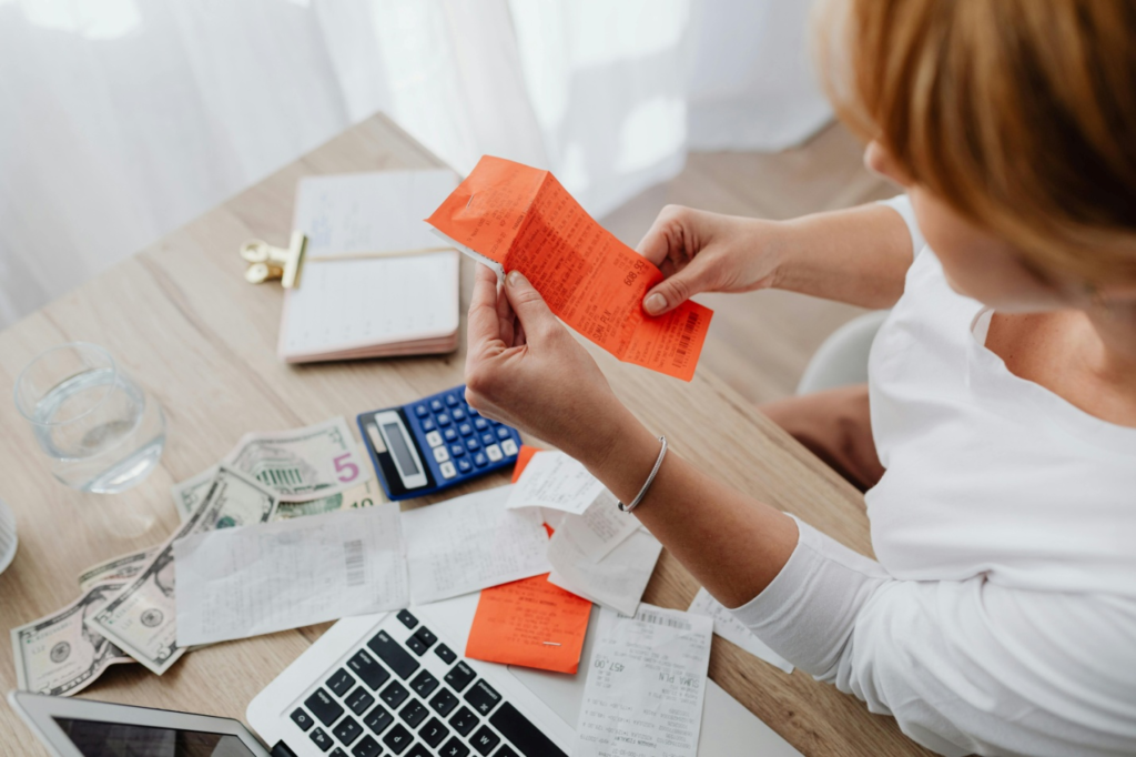 A woman looking at a receipt